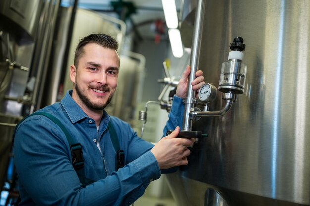 Brewer checking pressure at brewery