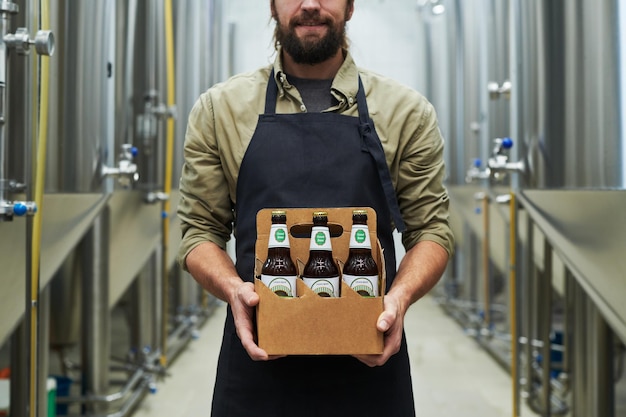 Brewer showing bottled beer