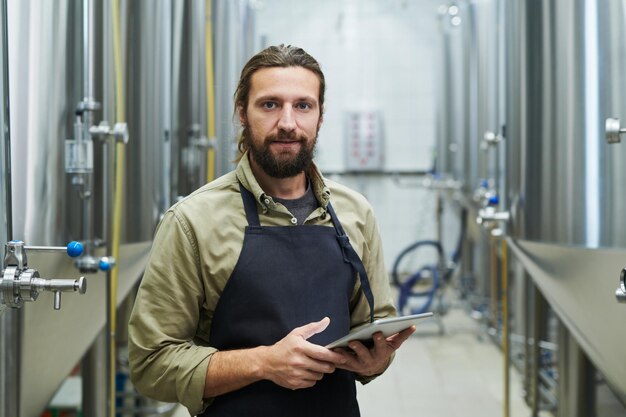 Brewery worker with tablt computer