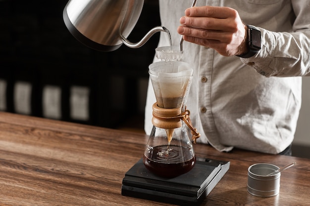 Brewing Pour Over Style of Coffee Making Dripping with Bubbles. Alternative coffee-making methods. Beautiful close up view or preparing morning coffee. Coffee industry. Coffee shop concept