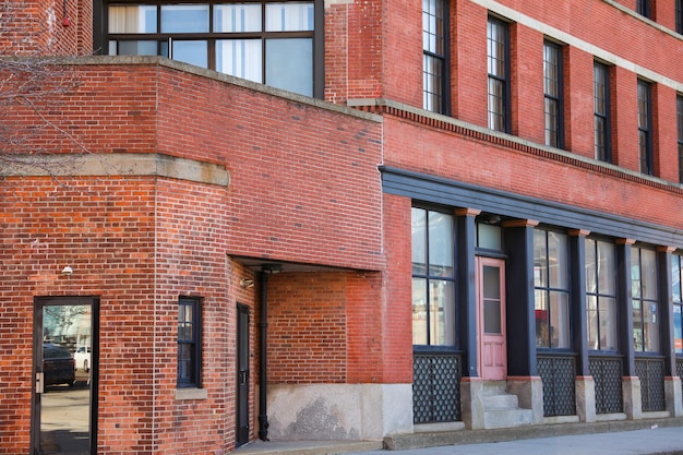 A brick building with a red door and windows that says " the word " on the front. "