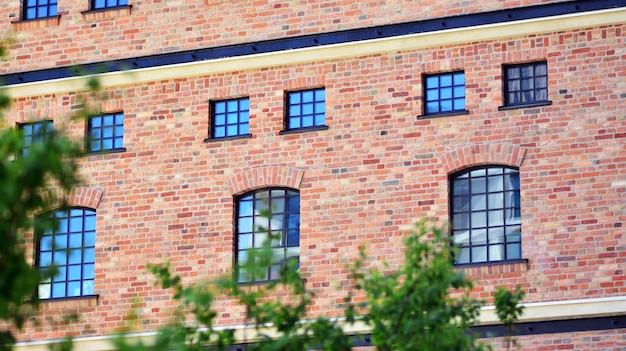 a brick building with windows and a brick wall