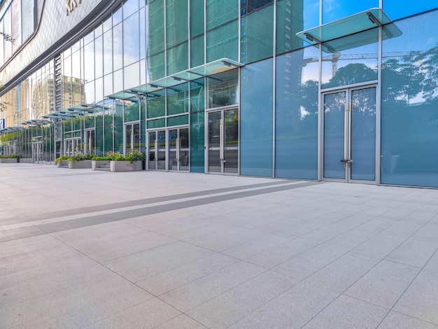 Brick floor and modern building glass wall facade square\
artificial space background