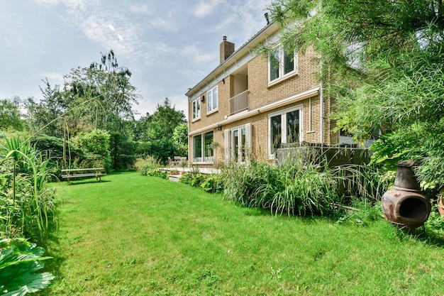 a brick house with a green yard and a garden