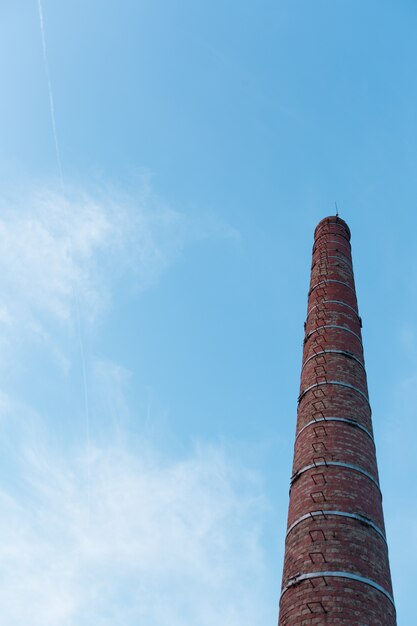Brick industrial pipe against the sky. 