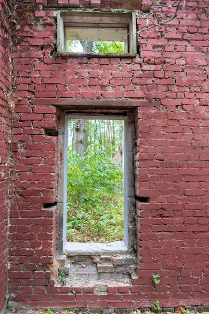 A brick opening without a window of an old and destroyed building