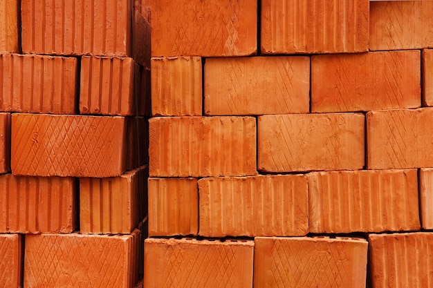 Brick pallets and packages of freshly produced red bricks Brick background