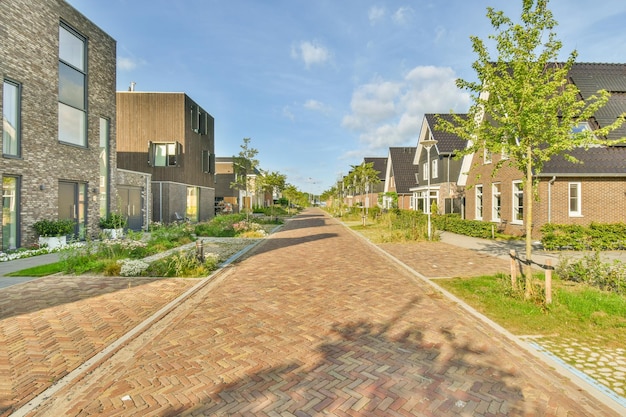 A brick road with houses on both sides of it