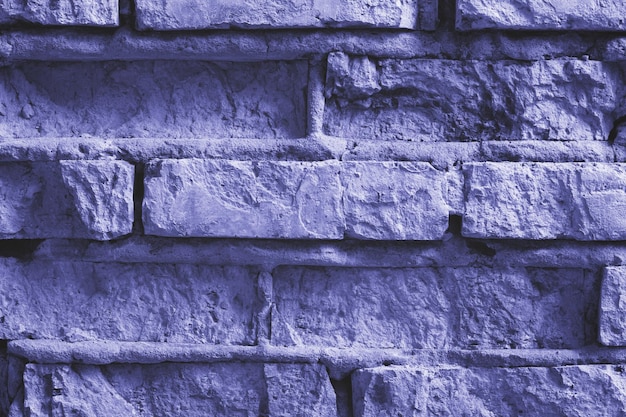 Photo brick wall background tinted in a trendy very peri color