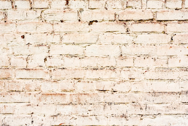 Foto sfondo texture muro di mattoni. texture di mattoni con graffi e crepe