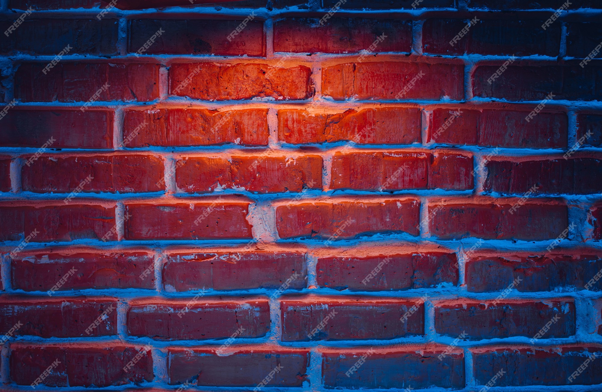 Premium Photo | Brick wall texture background in red and blue neon lights