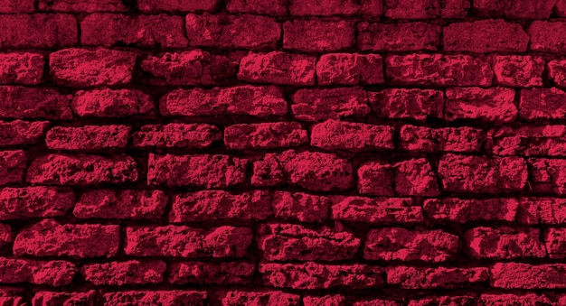 Photo brick wall tinted in the color of the year 2023 viva magenta, space for text, banner