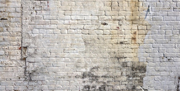 A brick wall with black marks on it