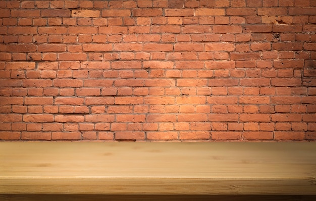 Brick wall with empty wooden table