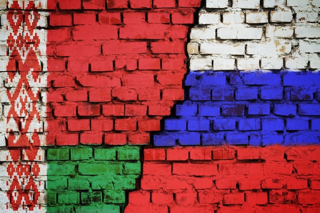 Brick wall with a flag of Belarus and Russia