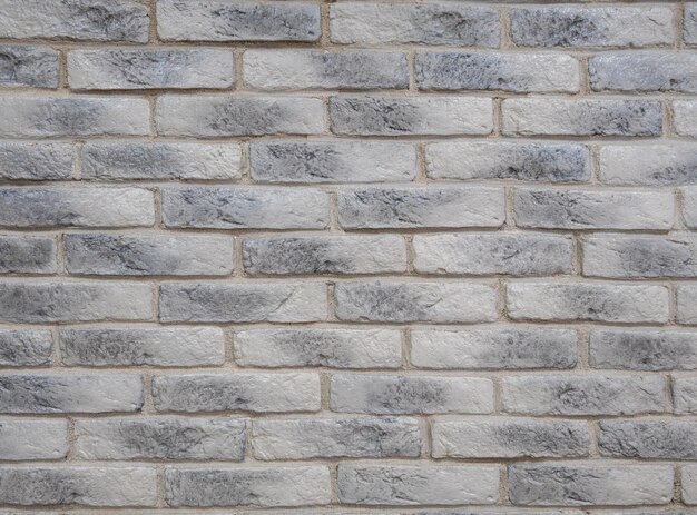 A brick wall with grey bricks and the word stone on it.