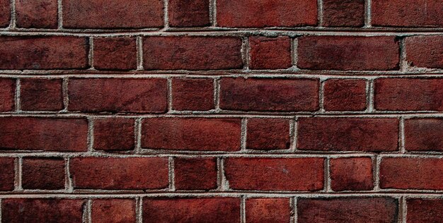 A brick wall with a red brick background