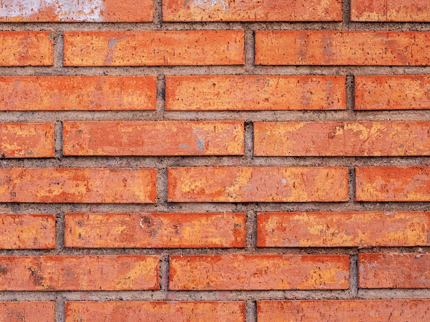 A brick wall with a red brick background