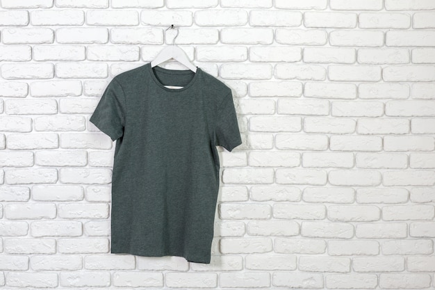 Brick whitewashed wall with t-shirt on hanger