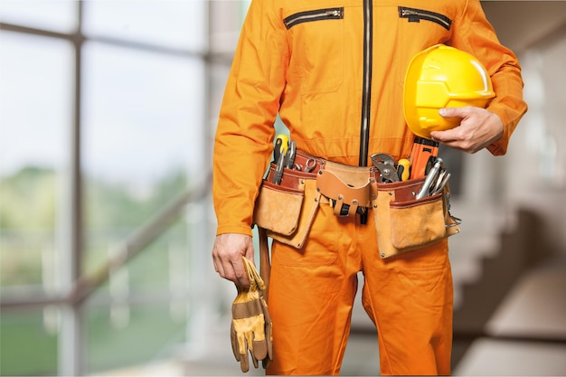 Bricklayer hands holding hardhat