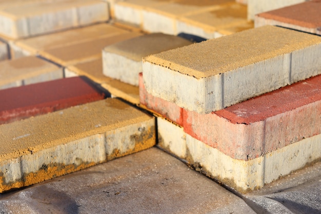 Bricks of building materials in anticipation of stoic work lie on the street