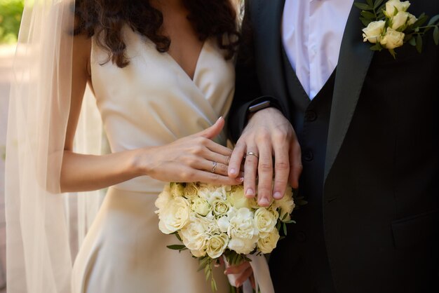 Bridal bouquet in brides hands bride in the garden