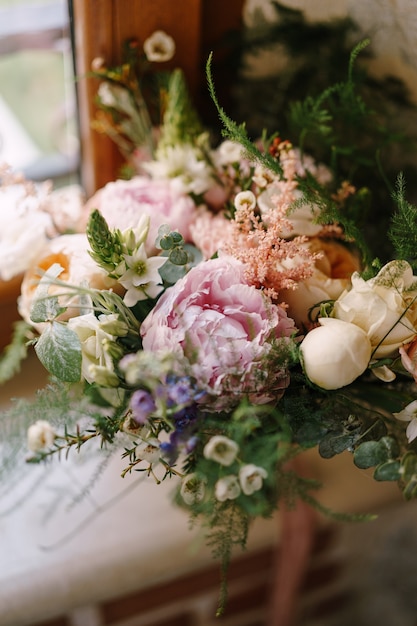 Photo bridal bouquet of cream roses pink peonies eustoma waxflower astilbe limonium branches of eucalypt