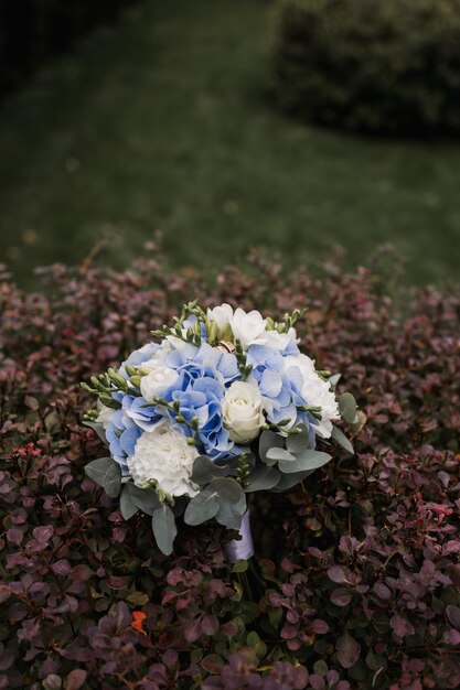 Bridal bouquet of flowers with gold wedding rings