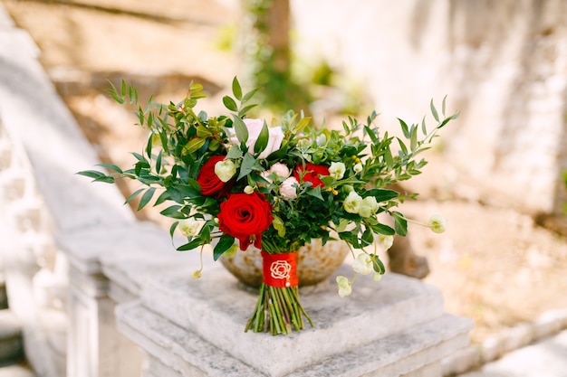Bridal bouquet on the railing of an ancient staircase