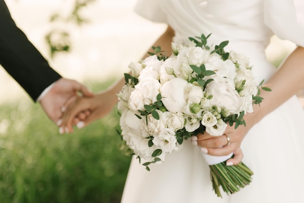 Bridal bouquet of white peonies and roses