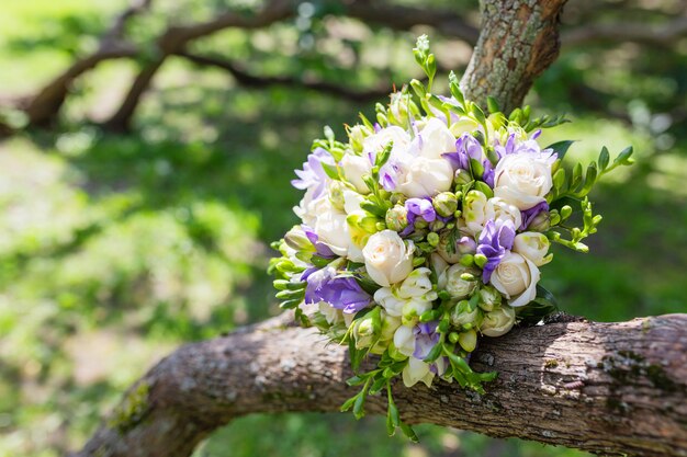 Bridal bouquet with roses and freesia flowers, traditional floral composition for wedding ceremony.