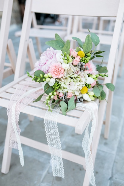 Bridal bouquet on a wooden chair