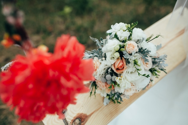 "Bridal bouquet on wooden swing."