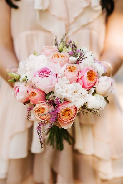 Bridal morning details. Wedding bouquet in the hands of the bride