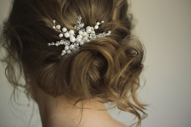 Bridal wedding hairstyle with jewelry. Elegant hair accessorie.