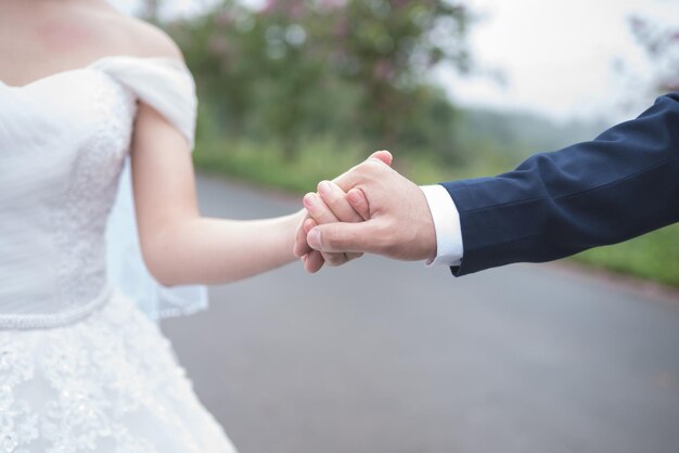 写真 道で手をつないでいる新郎と新婦