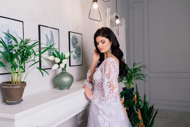 Bride on the background of new year lights, christmas interior