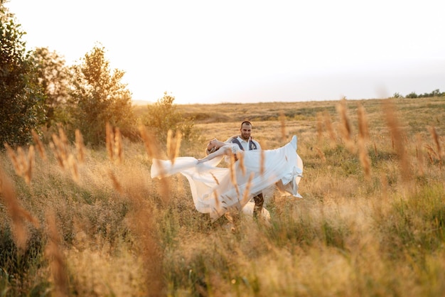 Bride blonde girl and groom in a field