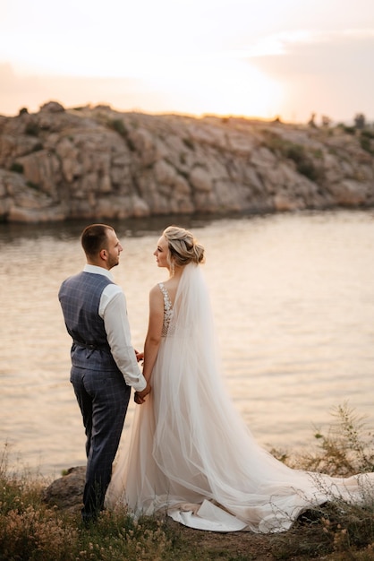 Bride blonde girl and groom near the river