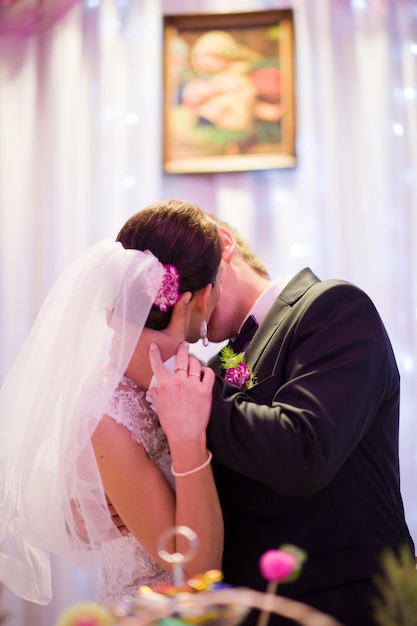 Bride and bridegroom kissing