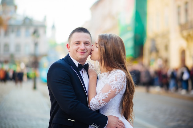 Bride and bridegroom standing with bouquet