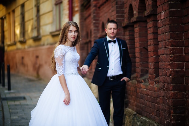 Bride and bridegroom standing with bouquet