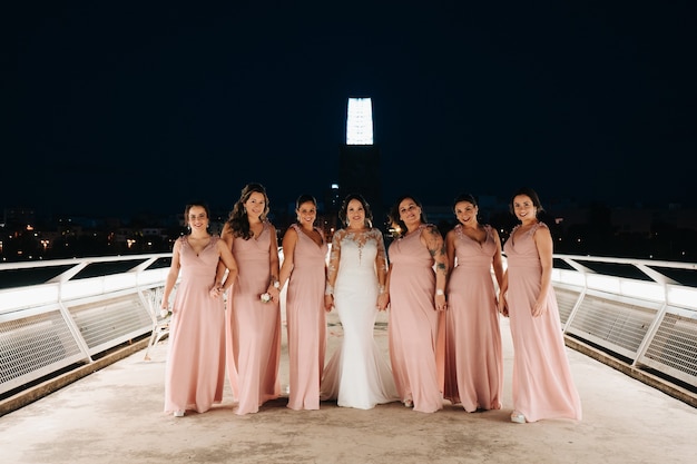 Bride and bridesmaids looking at the camera