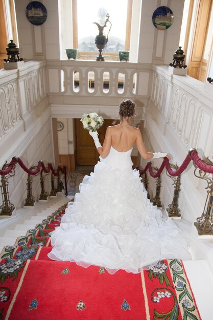 A bride descends a staircase to see her groom