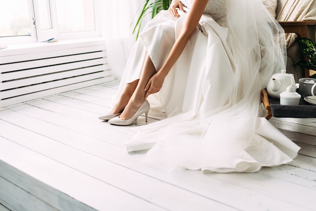 Foto la sposa veste le scarpe prima del matrimonio