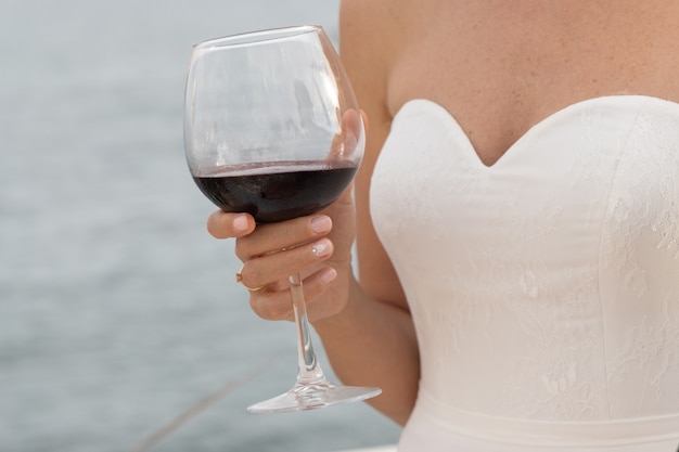 A bride drinking red wine