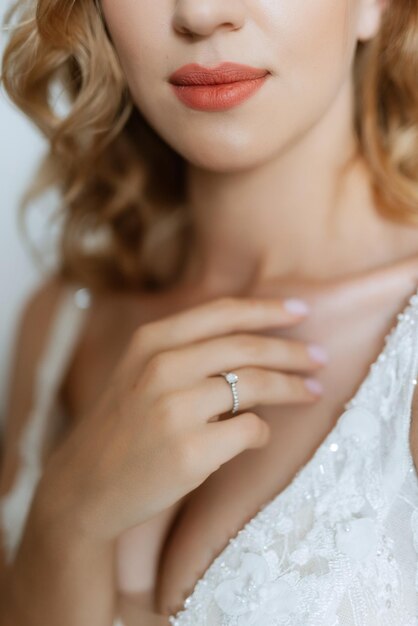 The bride gently touches her dear ring