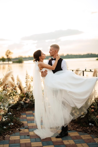 Bride and groom against the backdrop of a yellow sunset