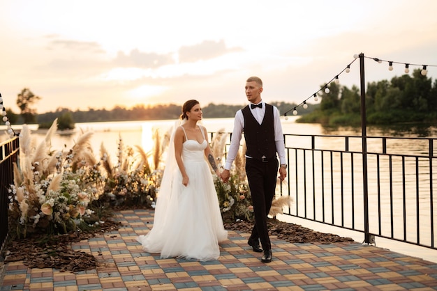 Bride and groom against the backdrop of a yellow sunset