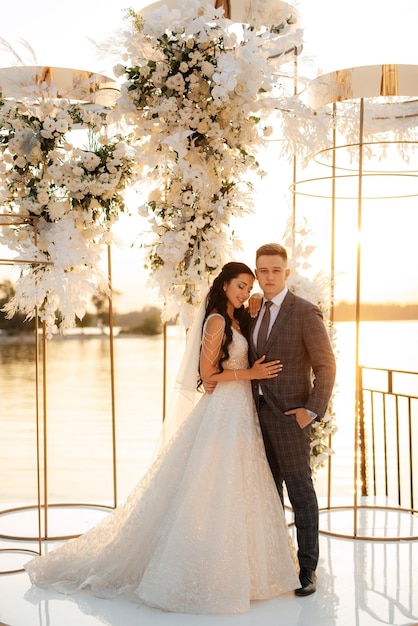 Bride and groom against the backdrop of a yellow sunset